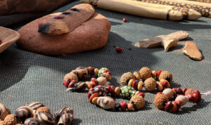 The women make jewellery using traditional cultural methods and materials during a cultural workshop.