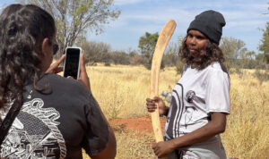 Connie takes a photo of Sarah at the cultural workshop. Photo by Cheyne Grace, Alice Springs media.